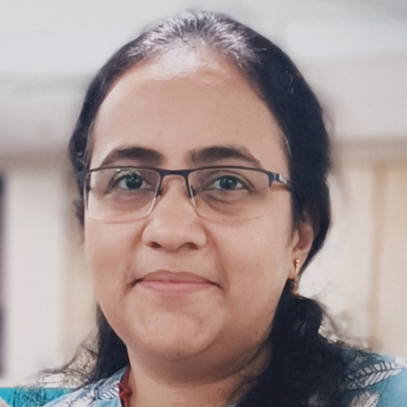 a person with glasses smiling