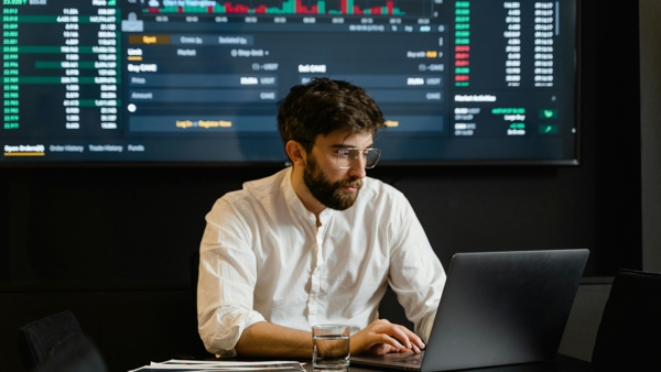 a person sitting at a desk with a laptop