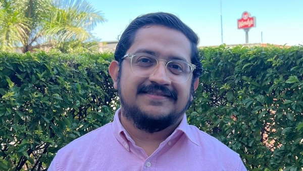 a person wearing glasses and a pink shirt