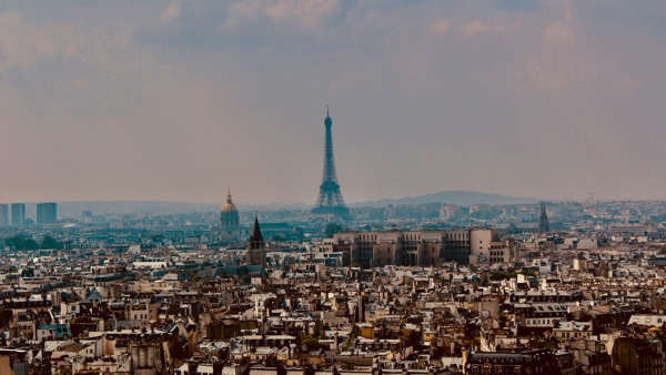 a city with a tall tower in the distance