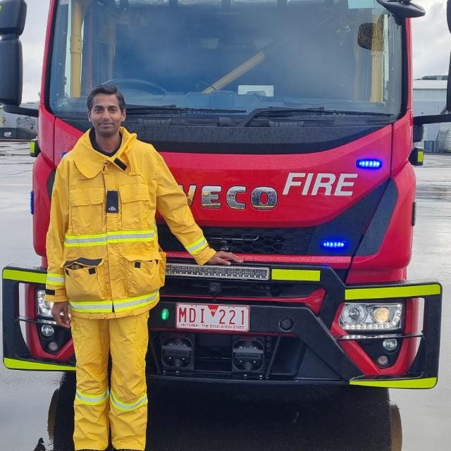 a person standing in front of a fire truck