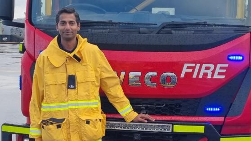 a person standing in front of a fire truck