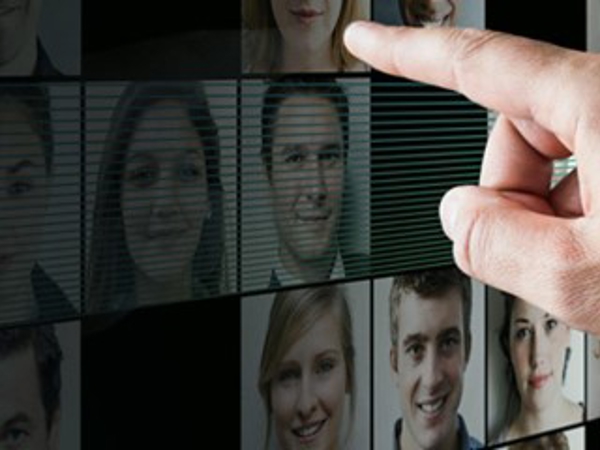 a finger pointing at a screen