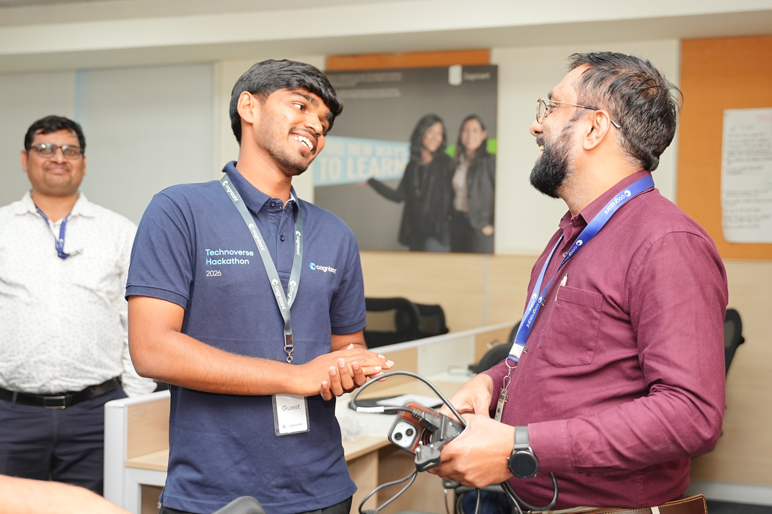 a person holding a device and another person shaking hands