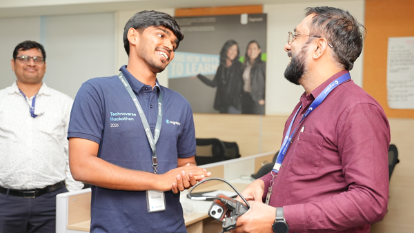 a person holding a device and another person shaking hands
