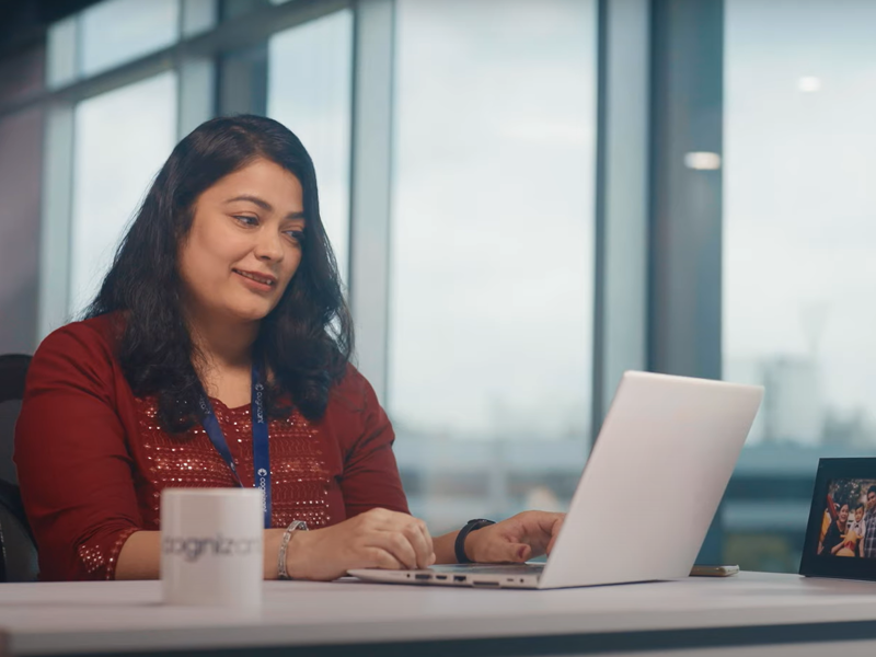 a person sitting at a desk with a laptop