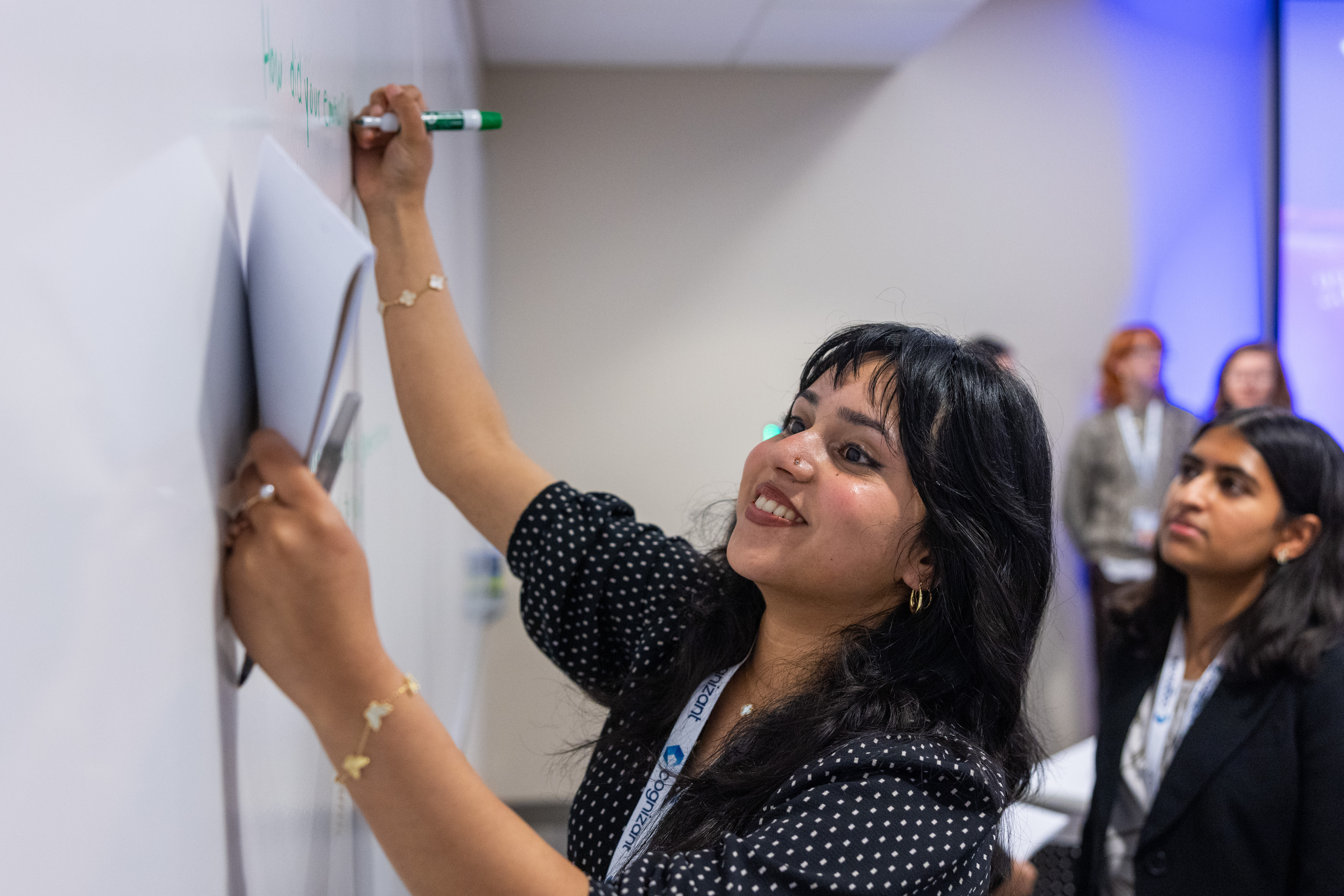 a person writing on a whiteboard
