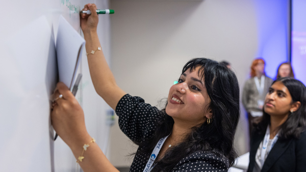 a person writing on a whiteboard
