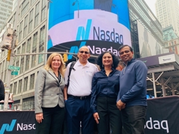 a group of people posing for a photo in front of a large building